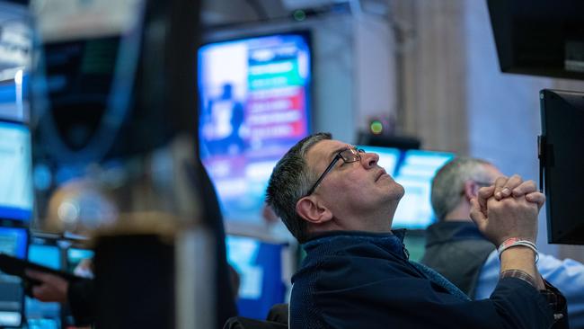 Traders work on the floor of the New York Stock Exchange as it fell into a bear market overnight. Picture: Jeenah Moon/Getty Images/AFP.