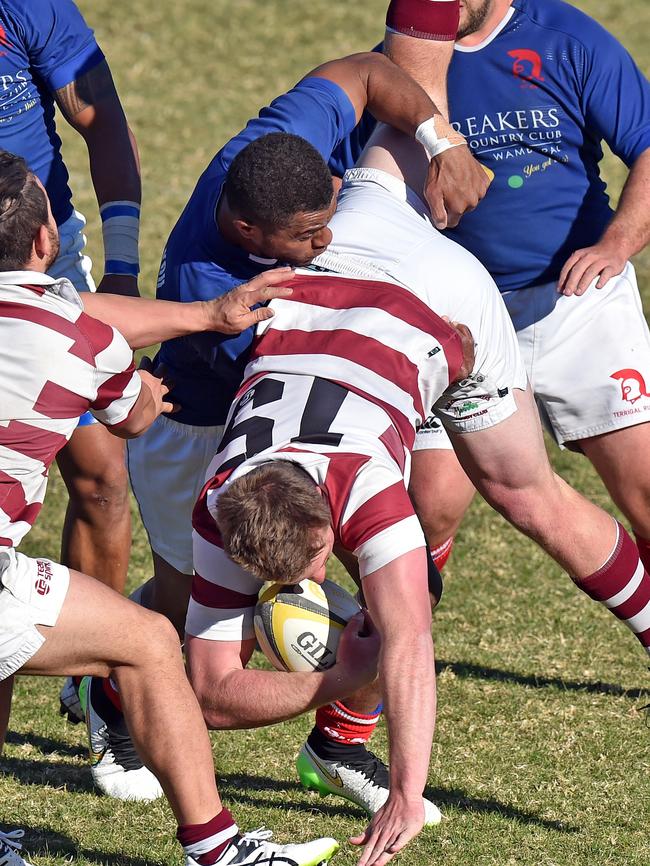 Terrigal’s Pat Niurua up-ends Kariong’s Jake Holwill yesterday.