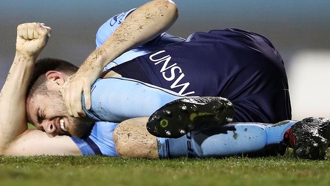 Sydney FC defender Ben Warland clutches his left knee during the match against Melbourne City on Sunday. Picture: Getty Images 