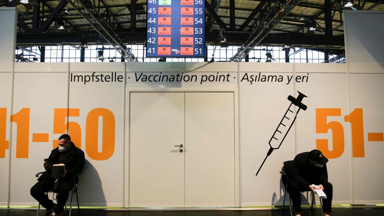 Two men wait for their vaccination in Berlin on December 27, 2020 Picture: Markus Schreiber/AFP