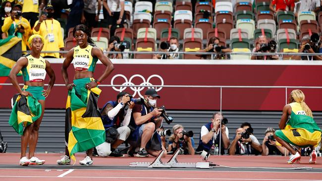 Shelly-Ann Fraser-Pryce and Shericka Jackson stand together leaving Elaine Thompson-Herah to celebrate solo. (Photo by Wang Lili/Xinhua via Getty Images)