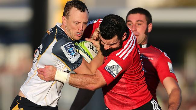 Jesse Mogg of the Brumbies is tackled by Ryan Crotty of the Crusaders during the round 12 Super Rugby match between the Crusaders and the Brumbies at AMI Stadium on May 3, 2014 in Christchurch, New Zealand. (Photo by Martin Hunter/Getty Images)