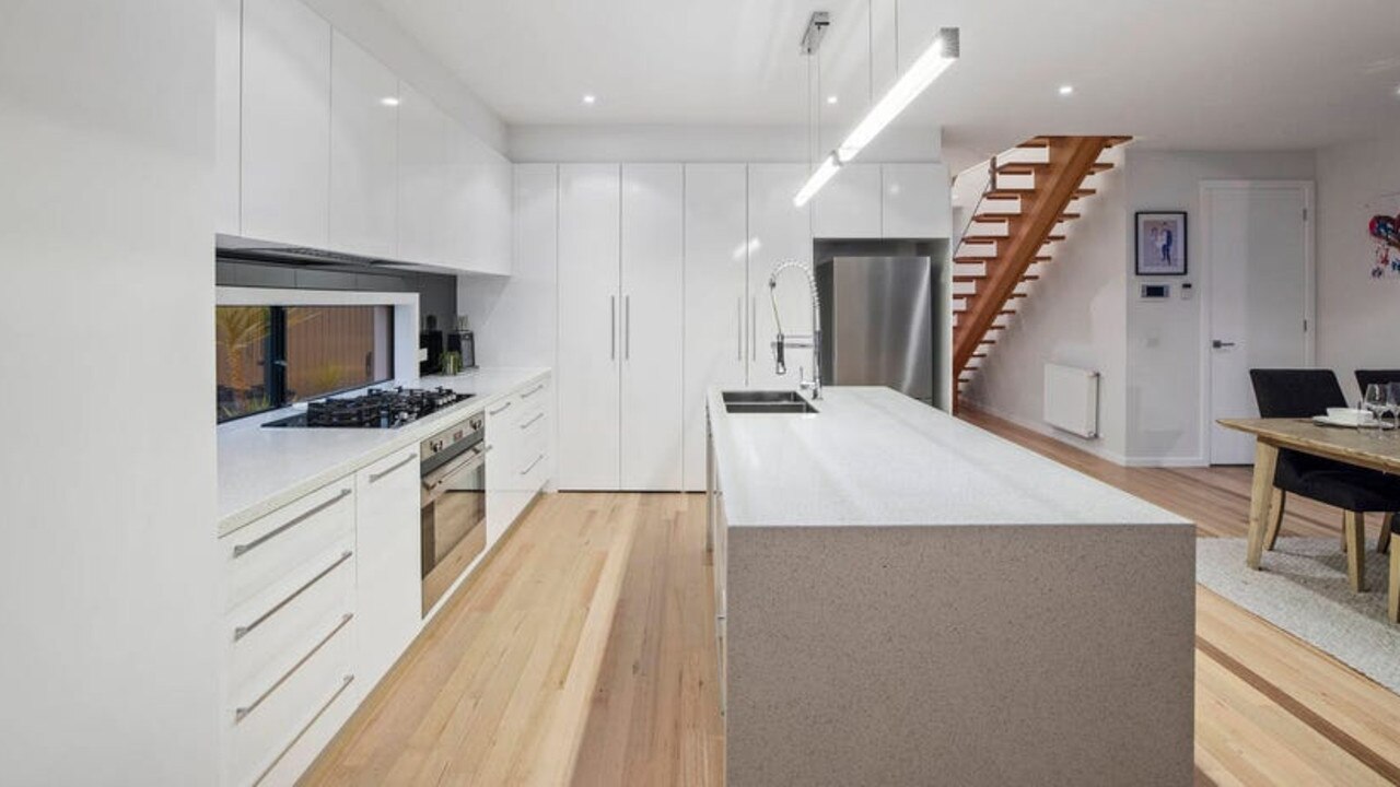 The stylish kitchen has a Caesarstone bench.