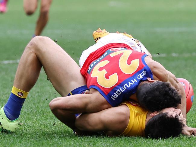 PERTH, AUSTRALIA - JULY 14: Liam Duggan of the Eagles lies concussed tackled by Charlie Cameron of the Lions during the 2024 AFL Round 18 match between the West Coast Eagles and the Brisbane Lions at Optus Stadium on July 14, 2024 in Perth, Australia. (Photo by Will Russell/AFL Photos via Getty Images)