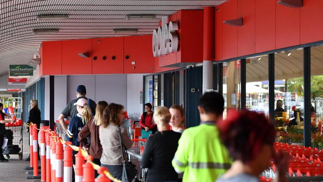 Shoppers line up outside a Coles supermarket to comply with social distancing guidelines. Picture: AAP