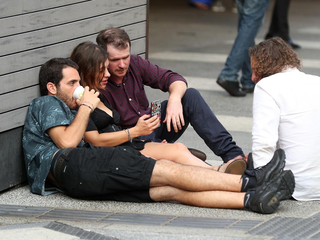 New Year’s Eve revellers the morning after in Fortitude Valley Mall. Picture: Liam Kidston