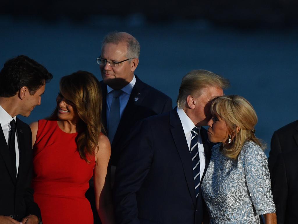 Canada's Prime Minister Justin Trudeau greets U.S. First Lady Melania Trump, while President Trump kisses France's First Lady Brigitte Macron and Australia's Prime Minister Scott Morrison hovers in the background. Picture: AAP Image/Mick Tsikas.