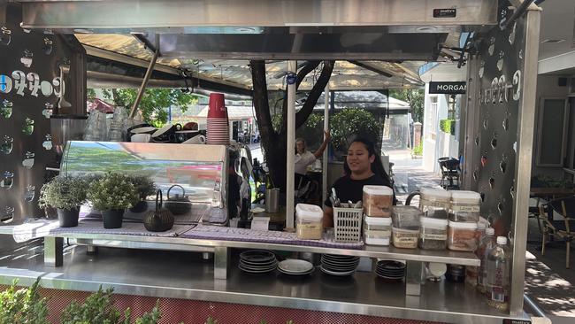 The coffee cart operates in the outdoor dining area.