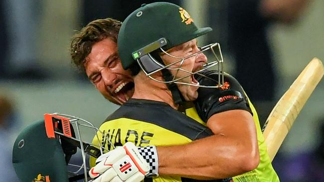 Australia’s Marcus Stoinis (rear) and Matthew Wade celebrate their unlikely victory over Pakistan in the T20 World Cup semi-final in Dubai. Picture: AFP