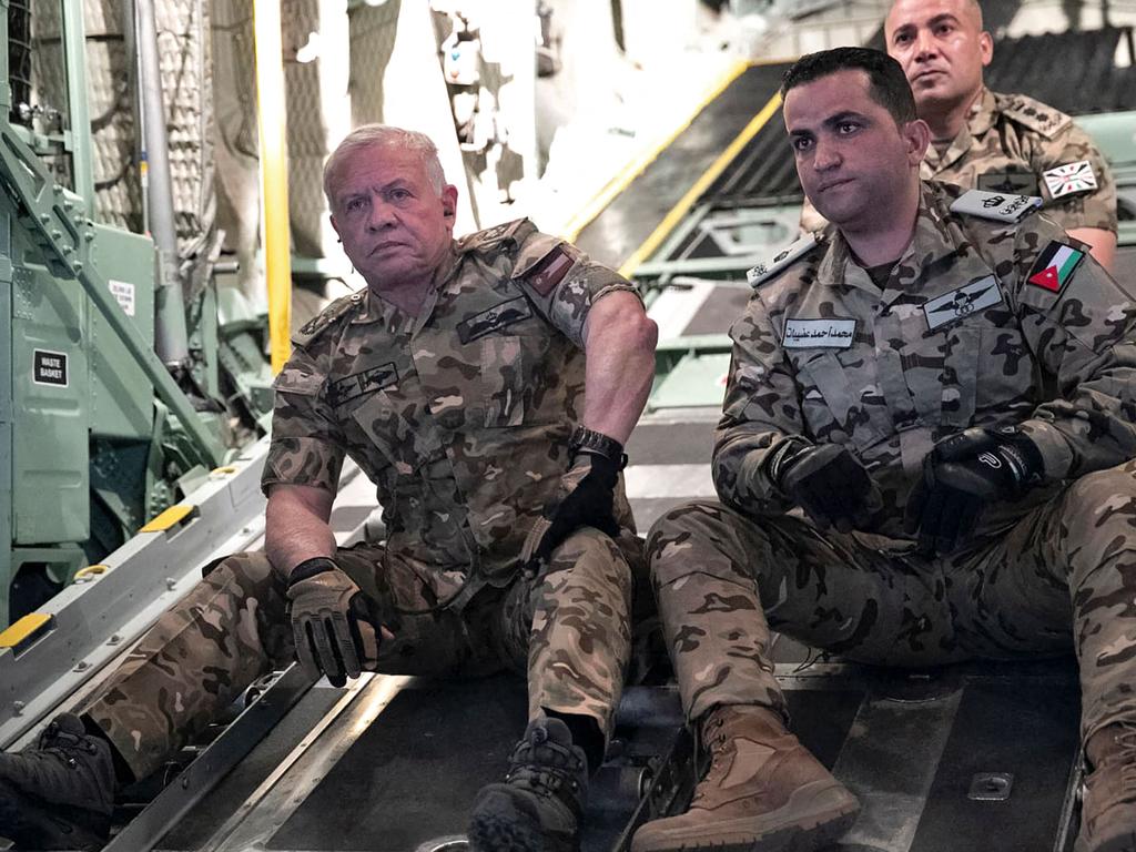 Jordan's King Abdullah II (L) on board a military aircraft during an operation to drop humanitarian aid over the southern Gaza Strip. Picture: Jordan Public Security / AFP