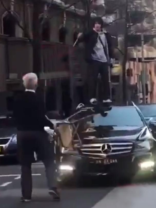 Ney wielding a butcher’s knife on top of a car. Picture: Seven News