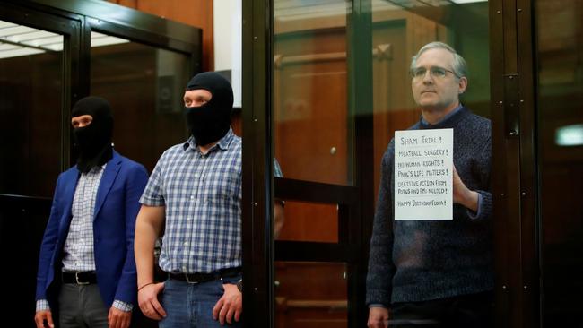 Whelan holds a sign denouncing the legal proceedings against him during a 2020 court appearance. Picture: Maxim Shemetov/Reuters/WSJ