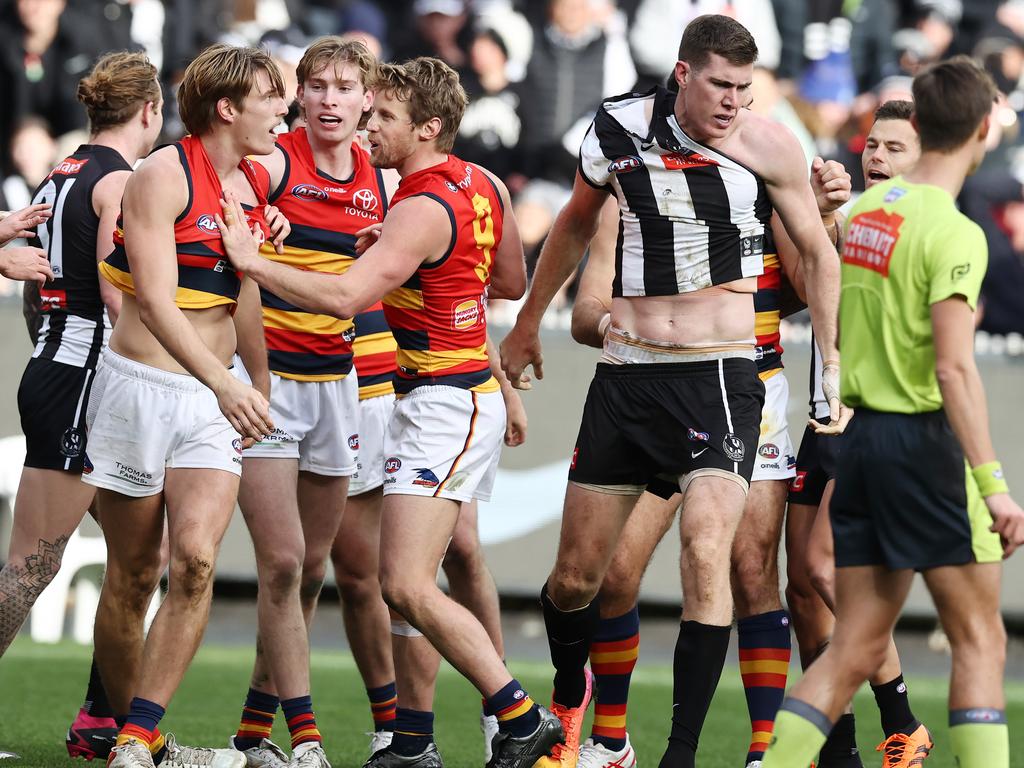 Mason Cox of the Magpies runs at Josh Worrell of the Crows after kicking a goal. Picture: Michael Klein