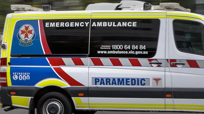 MELBOURNE, AUSTRALIA - NewsWire Photos FEBRUARY 13, 2022: An ambulance speeds away from the Royal Melbourne Hospital. Ambulance, Generic.Picture: NCA NewsWire / David Geraghty