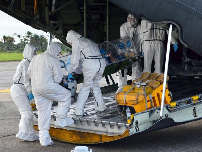 Sign of the times ... a military medical team transfer a priest who contracted Ebola in Sierra Leone and later died in Spain. Picture: AFP / SPANISH DEFENCE MINISTRY