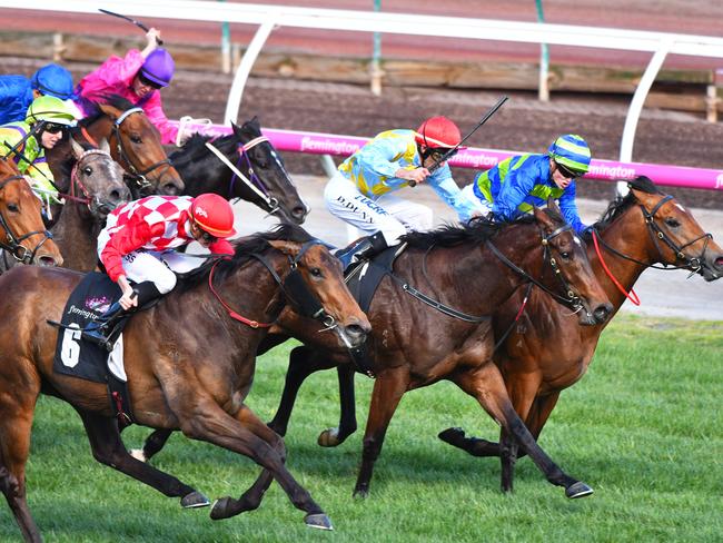 Catch me if you can: Regan Bayliss and Catchy (red/white silks) unleash a powerful finishing burst to overhaul the leaders in the Danehill Stakes. Picture: Getty Images