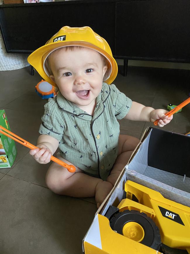 Braxton Davies opening his presents for his first birthday.