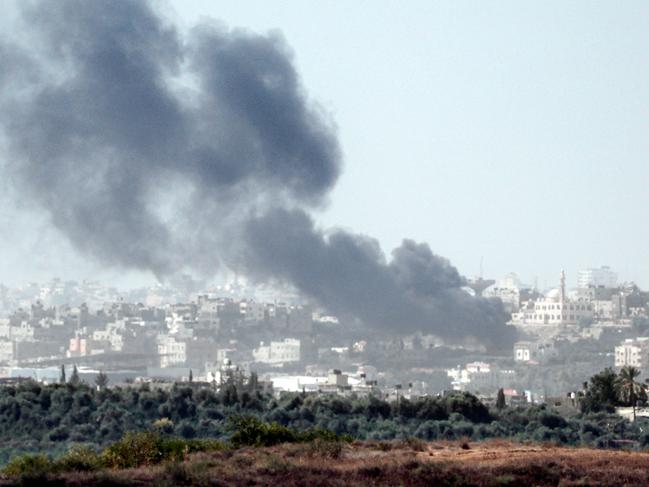 The Israeli city of Sderot shows black dust and smoke ascending in the Palestinian Gaza Strip. Picture: AFP