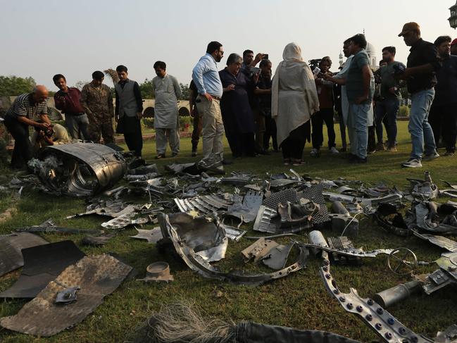 Journalists film missile fragments at the compound of an Islamic seminary after Indian strikes in Ahmedpur Sharqia, about 7 kilometers from Bahawalpur in Pakistan's Punjab province. Picture: Shahid Saeed Mirza / AFP
