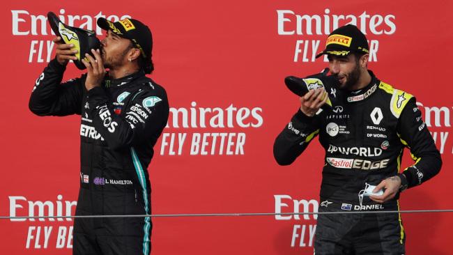 Lewis Hamilton joins Daniel Ricciardo for a toast.