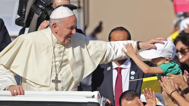 Pope Francis blesses a child as he arrives to lead mass for an estimated 170,000 Catholics at the Zayed Sports City Stadium. Picture: Karim Sahib / AFP