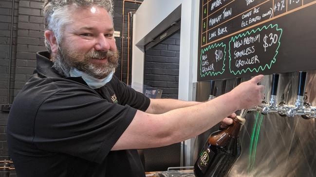 8 Track Brewery founder Trent Hislop begins dishes out the growlers at the opening of the Ringwood microbrewery on Thursday, September 2. Picture: Kiel Egging.