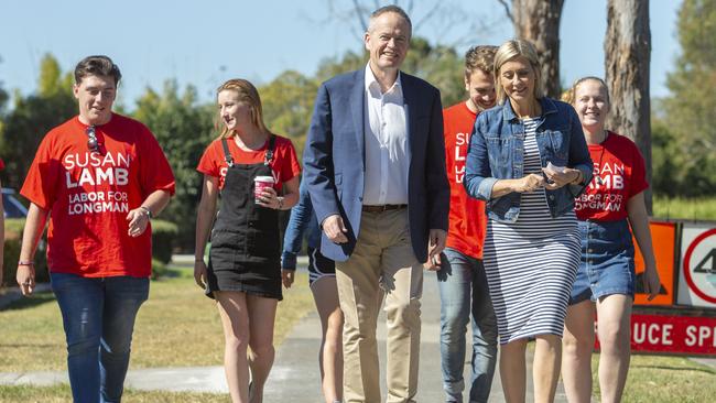 Opposition leader Bill Shorten walks to a doorstop with newly elected member for Longman Susan Lamb. Picture: AAP