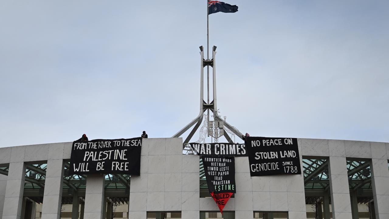 The activists breached security to stage their protest on the roof of Parliament House. Picture: NewsWire/ Martin Ollman