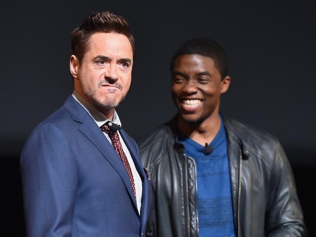 LOS ANGELES, CA - OCTOBER 28: Actors Robert Downey Jr. (L) and Chadwick Boseman onstage during Marvel Studios fan event at The El Capitan Theatre on October 28, 2014 in Los Angeles, California. (Photo by Alberto E. Rodriguez/Getty Images for Disney)