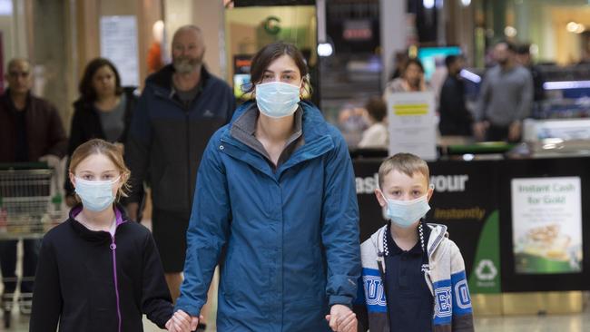 Danielle Tatters with children Emily and Jack wear their masks while shopping. Picture: Rob Leeson