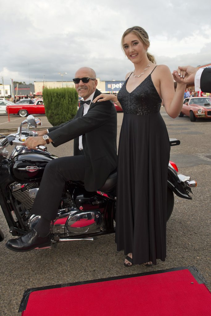 Elise Power arrives on a motorbike ridden by John Thuijs. Picture: Kevin Farmer