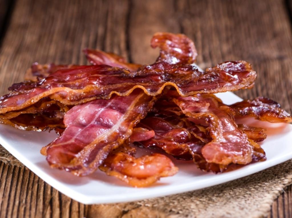 RendezView. Fried Bacon (selective focus) on an old vintage wooden table. (Pic: iStock)