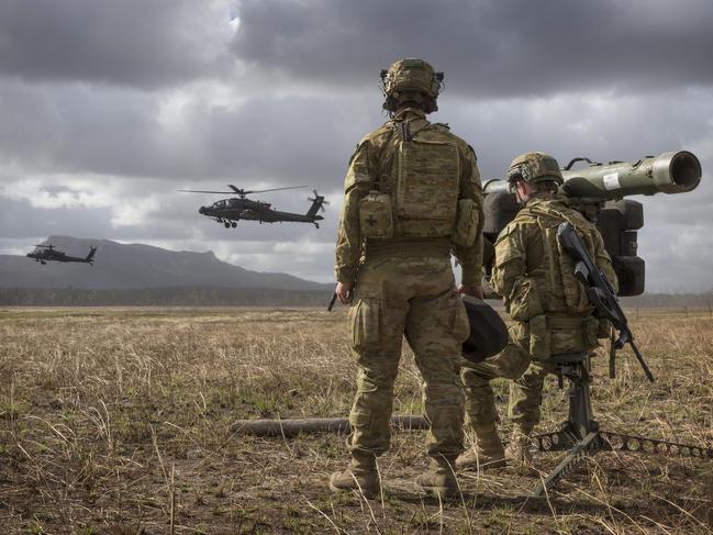 Members of 16th Regiment armed with their RBS-70 watch over the battlefield as two US Army Apache Attack helicopters demonstrate their capability at Shoalwater Bay Training Area in central Queensland.