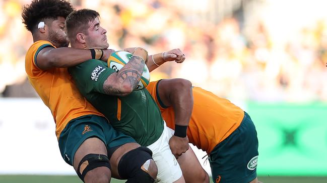 Malcolm Marx of the Springboks is tackled by Dave Porecki and Rob Valetini.