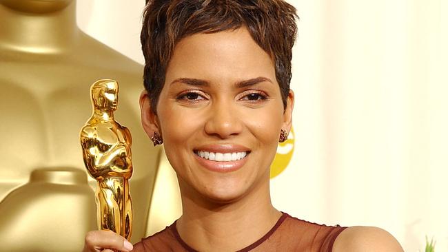 Halle Berry holds her Oscar statuette backstage at the 74th Annual Academy Awards in 2002.