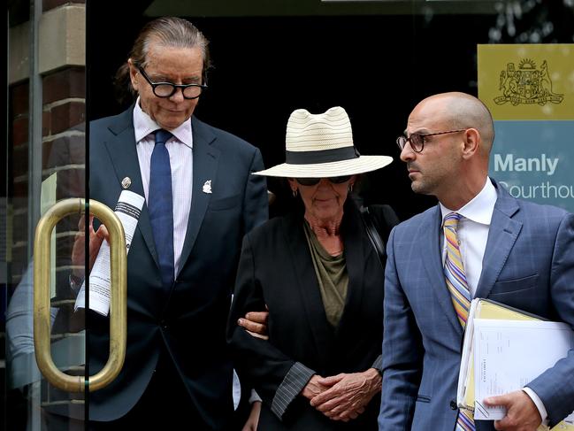 Lawyer Charles Waterstreet (left) leaves Manly Courthouse with the mother of Matthew Flame. Picture: Toby Zerna