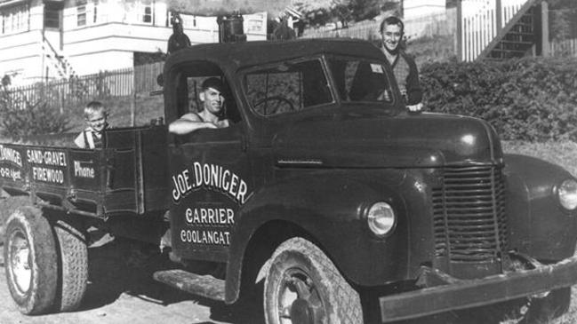 Joe Doniger driving his truck — young son George is in the back.