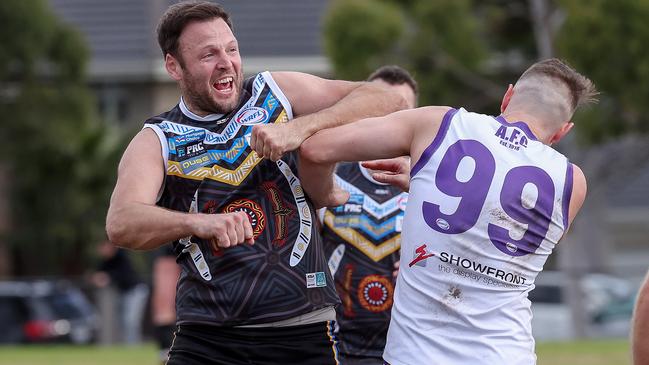 WRFL: Caroline Springs’ Ryan Allan celebrates a goal getting into Mitchell Turnbull of Altona. Picture: George Salpigtidis