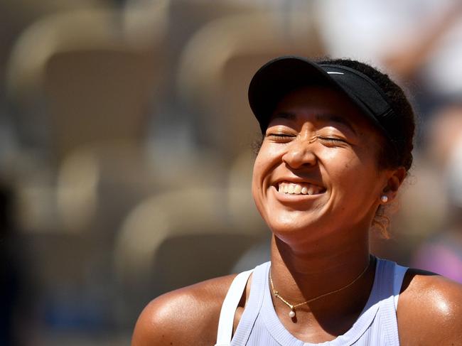 Japan's Naomi Osaka manages to smile, despite losing to Katerina Siniakova.