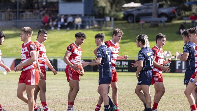 Players from Palm Beach Currumbin SHS captain Tanu Nona, middle, shakes hands against Mabel Park.