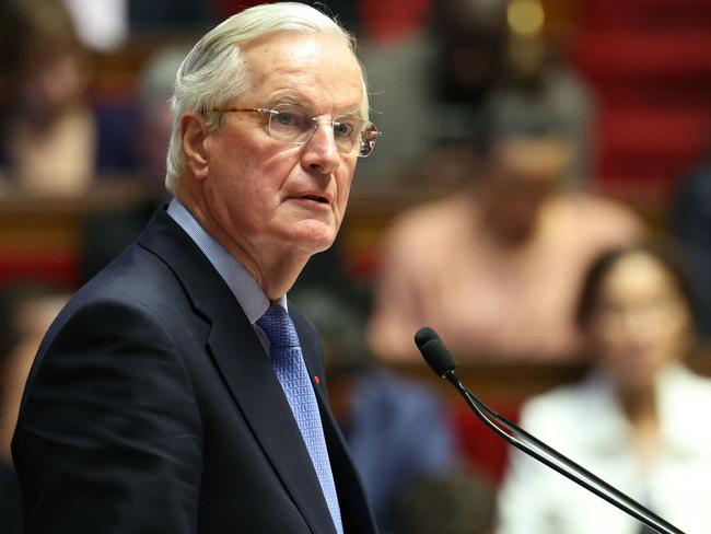 French Prime Minister Michel Barnier delivers a speech during the debate prior to the no-confidence votes on his administration at the National Assembly in Paris on December 4, 2024. The French National Assembly debates two motions brought by the French left-wing Nouveau Front Populaire (New Popular Front) NFP coalition and the French far-right Rassemblement National (National Rally) RN party in a standoff over 2025's austerity budget, which saw French Prime Minister force through a social security financing bill without a vote (article 49.3) on December 2, 2024. (Photo by Alain JOCARD / AFP)