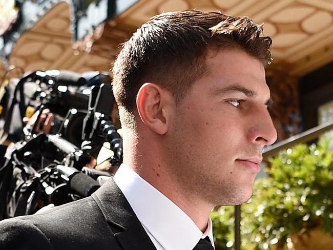 Lawyer Danny Eid (left) and NRL player Curtis Scott (centre) leave the Downing Centre Local Court in Sydney, Friday, January 31, 2020. Canberra Raiders NRL recruit Curtis Scott has pleaded not guilty to six charges including assaulting police during Australia Day celebrations. (AAP Image/Bianca De Marchi) NO ARCHIVING