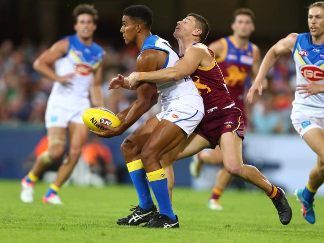 Touk Miller of the Suns is tackled by Dayne Zorko of the Lions during the round five AFL match between the Brisbane Lions and the Gold Coast Suns at The Gabba on April 22, 2018 in Brisbane, Australia. Picture: Chris Hyde/Getty Images.