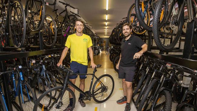 Tennis player John Millman picks up his bike from 99 Bikes CEO Matt Turner in Brisbane. Picture: Glenn Hunt