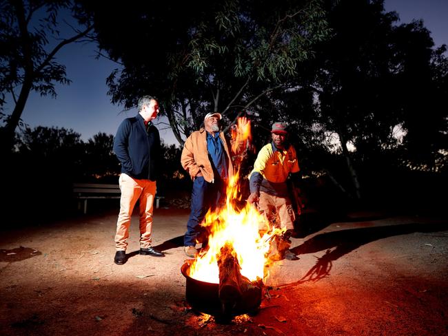 Steven Marshall, Lee Brady, and Adam Richards talk around a campfire in the APY lands. Picture: Dylan Coker