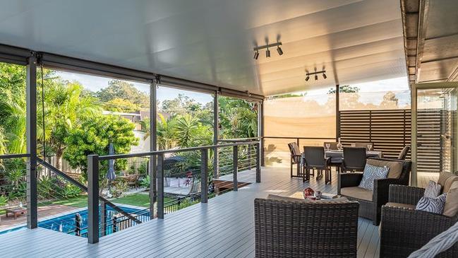 A generous rear deck overlooks the pool area.