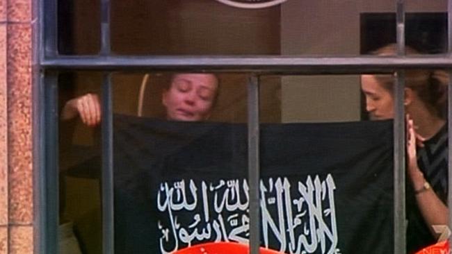 Terrified hostages forced to hold up a sign covered in Arabic writing during the stand-off. Katrina Dawson was killed during the siege. Picture: Channel 7