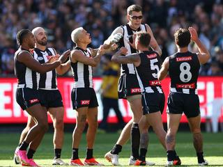 MELBOURNE, AUSTRALIA - APRIL 20: Mason Cox of the Magpies is congratulated by team mates after kicking a goal during the round six AFL match between Collingwood Magpies and Port Adelaide Power at Melbourne Cricket Ground, on April 20, 2024, in Melbourne, Australia. (Photo by Quinn Rooney/Getty Images)