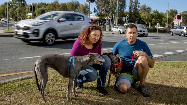 Kimberley Hagen with her partner Rick Taylor and their dogs Mischief and Jess at the intersection where she was hit by the car. Picture: Jerad Williams.