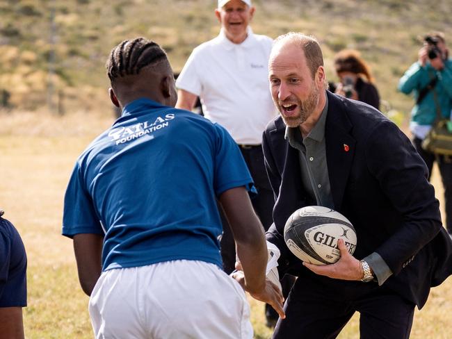 Prince William takes part in a rugby coaching session with local school children during a visit to Ocean View Secondary School in Cape Town, South Africa. Picture: Getty Images